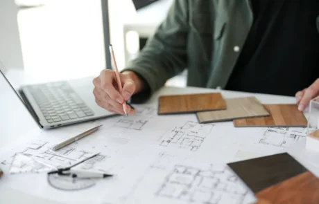 Diseñadores analizando distribución de espacios sobre planos técnicos